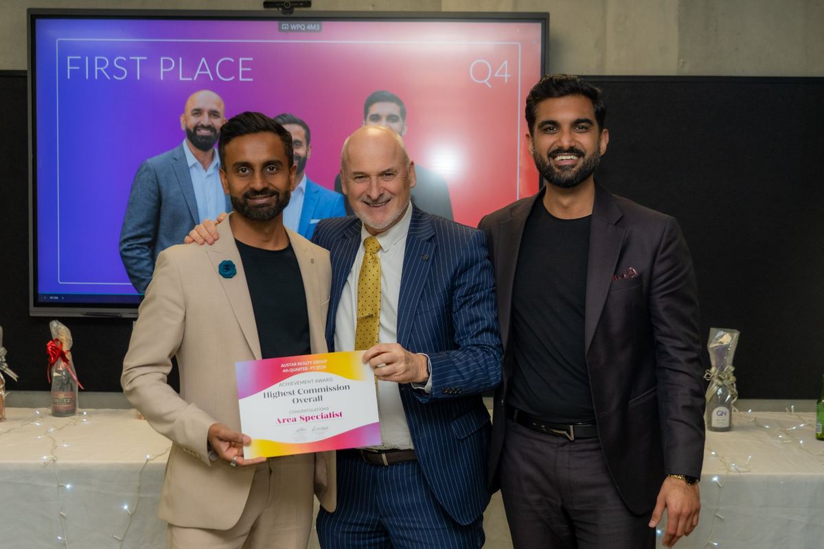 Area Specialist receiving the Austar Realty Group Highest Commission Overall achievement award for the fourth quarter of FY 2025–26