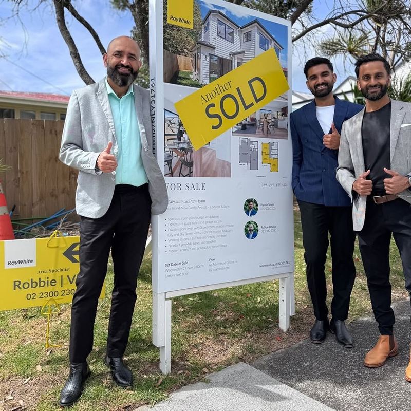 Area Specialist agents beside a Ray White SOLD sign for a new home on Westall Road, New Lynn, Auckland